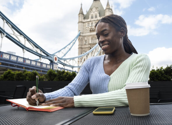 portrait-young-woman-with-afro-dreadlocks-city-having-coffee